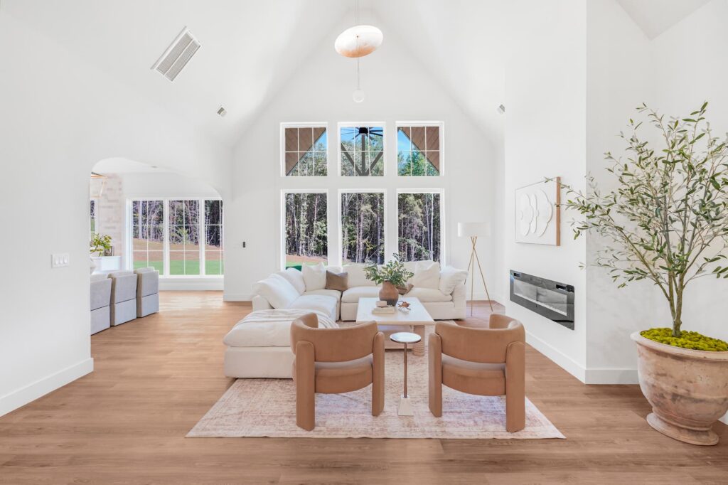 Vaulted great room with large windows in a Greenville semi-custom home