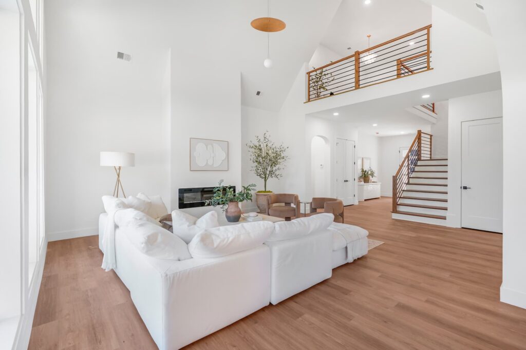 Living area with cable-rail staircase in a Greenville semi-custom home