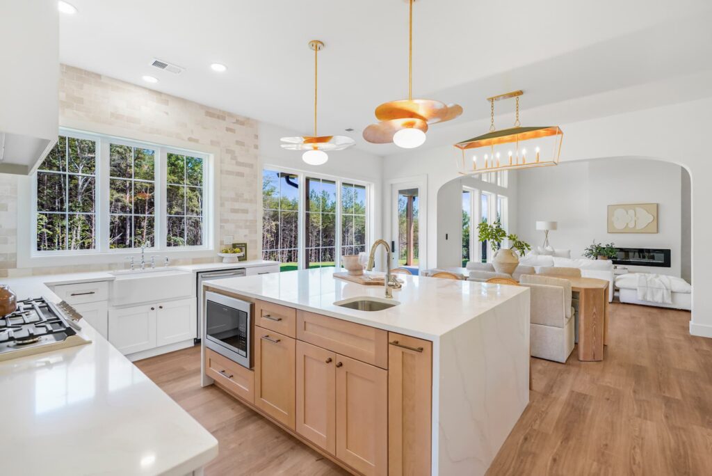 Kitchen with island and mixed brass lighting in a Greenville semi-custom home